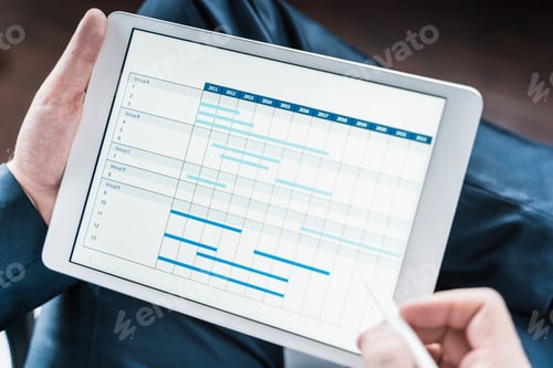 Preview: Working businessman,investor,trader.Financial report,presenatation in tablet.Diagram,gantt chart, an