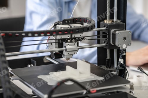 Preview: Student setting up 3D printer, close up