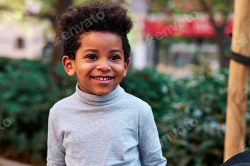 Preview: Happy brunette little boy in an urban park