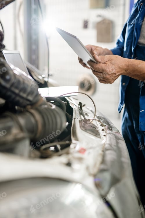 Preview: Digital tablet held by mature master of contemporary technical repair service