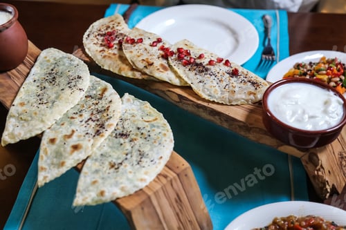 Preview: side view a traditional azerbaijani dish kutab with herbs and with meat yogurt on a stand