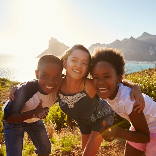 Preview: Portrait Of Smiling Children Standing On Cliffs By Sea