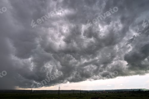 Preview: Landscape of dark ominous clouds forming on stormy sky during heavy thunderstorm