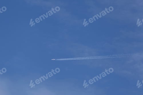 Preview: Jet Airplane Flying Across A Blue Sky With Scattered Clouds - Photograph Of A Jet Airplane Flying
