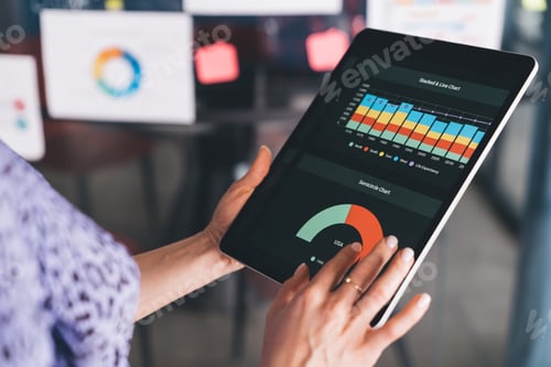 Preview: Cropped female employee working with online documents for analyzing graph charts
