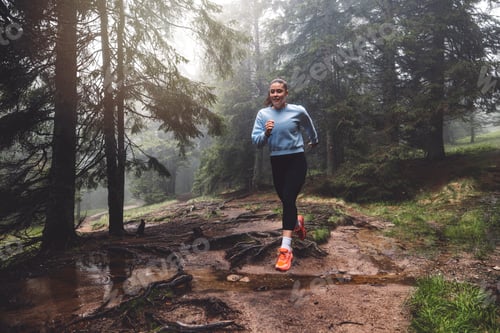 Preview: A person running through a misty forest, navigating over tree roots and muddy ground. The scene capt