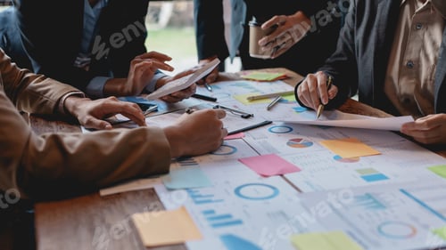 Preview: Groups of businesspeople working together as a team of analytics point to company graphs and charts