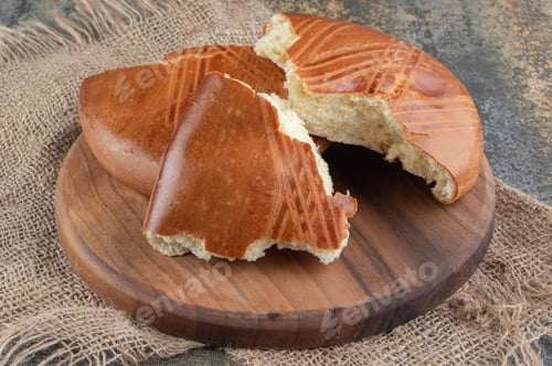 Preview: A wooden board of sweet delicious pastry on a sackcloth