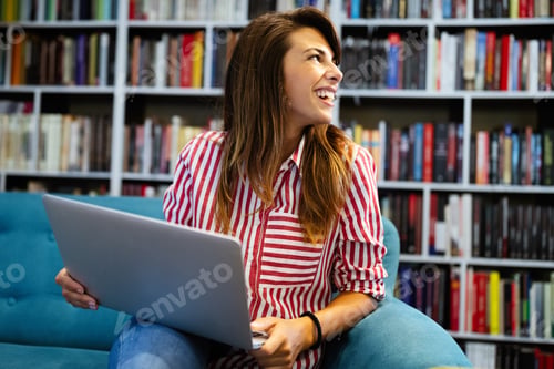 Preview: Portrait of happy student woman working on laptop
