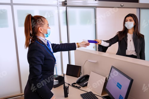 Preview: Passenger giving his documents for check-in to airport manager by counter