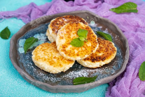 Preview: Sweet curd pancakes with mint. Cottage cheese pancakes or syrniki
