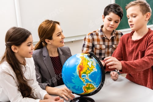 Preview: Teacher and pupils looking at globe while studying geography in classroom