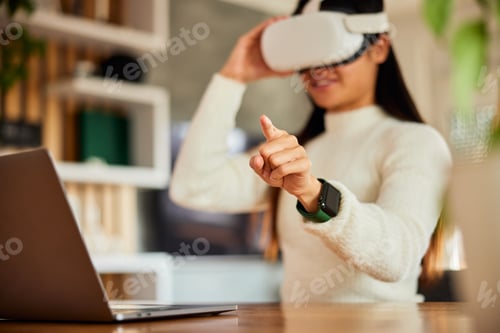 Preview: A female employee using a VR device for planning and developing business and strategy,