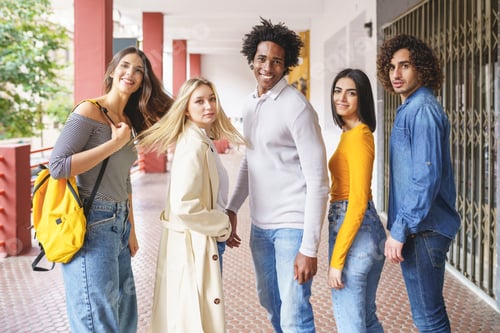 Preview: Group of beautiful friends of different ethnic having fun together in the street