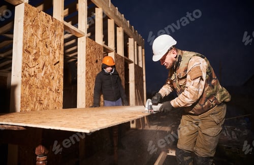 Preview: Carpenter using circular saw for cutting OSB board for building wooden frame house.