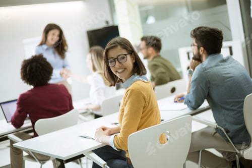 Preview: Young female student with eyeglasses in the classroom
