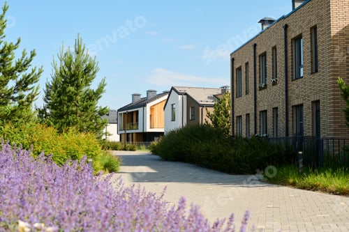 Preview: Two storey brick building standing against other cottages