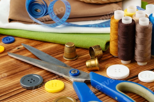 Preview: Crafting tools and materials arranged on a wooden table for sewing projects