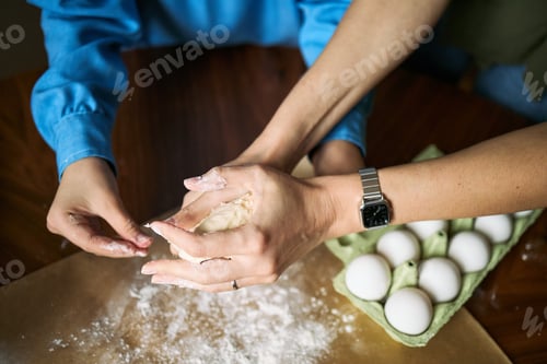 Preview: Adult Woman and Child Kneading Dough for Family Baking Activity