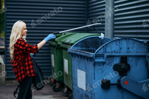 Preview: Volunteer puts plastic trash bag into the bin