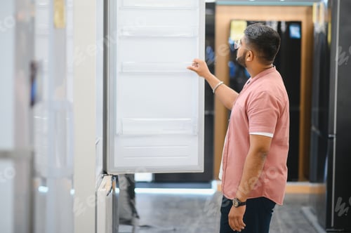 Preview: Indian man choosing washing machine at electronics store