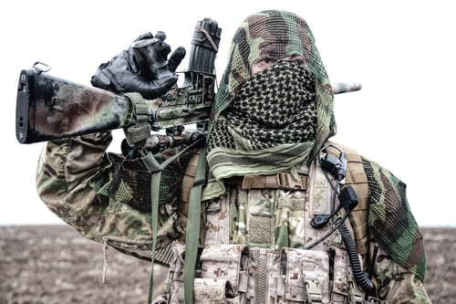 Preview: Army sniper standing in field with rifle