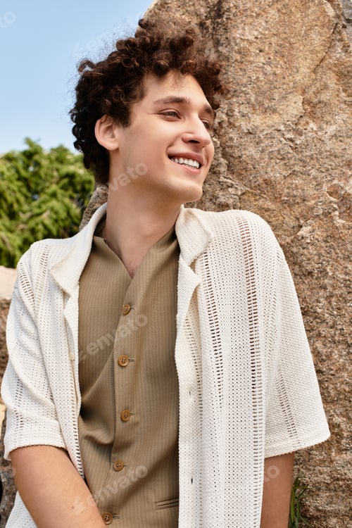Preview: Young man in stylish summer outfit radiates joy in green park under sunny skies