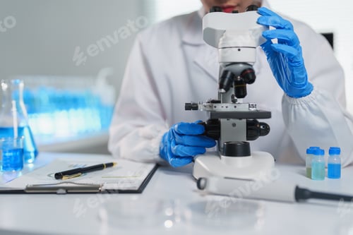 Preview: Scientist adjusting microscope, conducting research and analysis in a modern laboratory setting