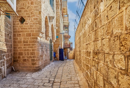Preview: Stone narrow streets of the Old City of Jaffa against blue sky with clouds