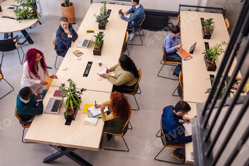 Preview: Coworkers collaborating and working in modern office space