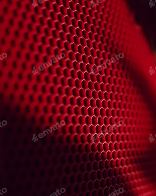 Preview: Selective focus shot of red honeycomb background with light falling on it