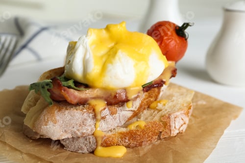 Preview: Delicious egg Benedict served on parchment, closeup