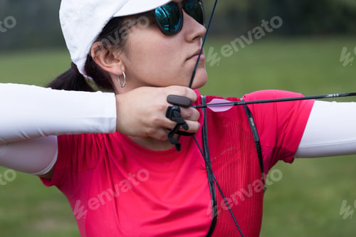 Preview: Female athlete practicing archery in stadium