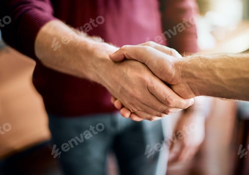 Preview: Closeup of two unrecognizable peoples hands greeting and shaking hands inside of a office at work