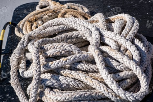 Preview: Boat rope old worn out, rope for ship mooring in the port, overhead closeup view