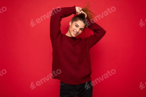 Preview: Young beautiful curly brunette woman with sincere emotions poising isolated on background wall with