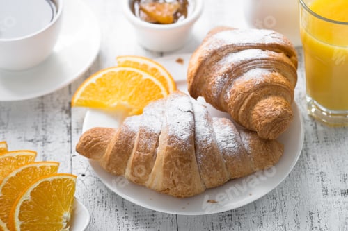 Preview: Croissant jam coffee orange jice at white wooden table.