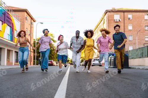 Preview: Multiethnic group of young friends meeting and having fun outdoors