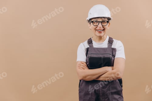 Preview: Smiling woman construction worker wearing hard hat and uniform