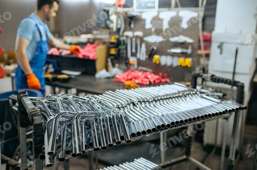 Preview: Bicycle factory, worker at row of bike handlebars