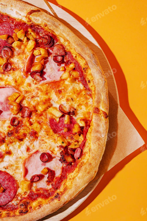 Preview: Colorful pizza topped with meats and vegetables on vibrant background
