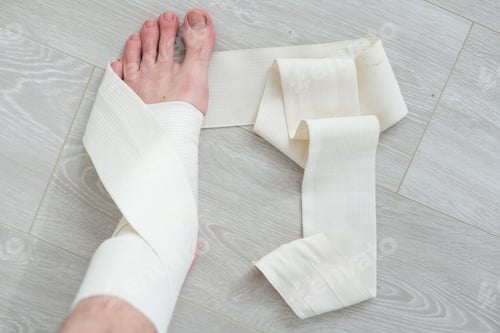 Preview: man using put on elastic bandage with legs having leg pain