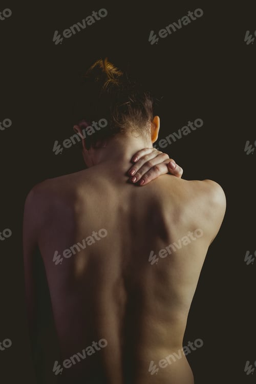 Preview: Nude woman with a neck injury on black background