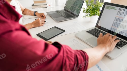 Preview: Young woman and man studying for a test or exam Tutor books with friends catching up and learning, e