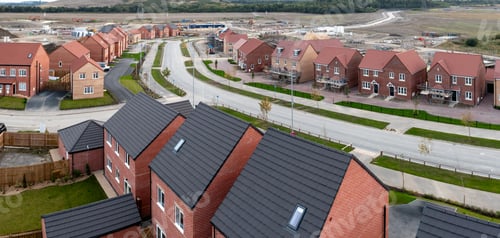Preview: Aerial panoramic view of a new build housing estate in the UK on a brownfield site