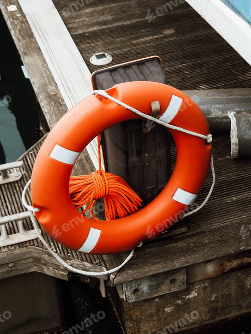 Preview: Lifebuoy in the marina. Life safety ring of a red buoy on a pole