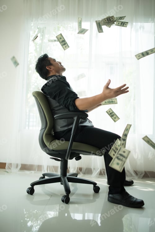Preview: Happy business man throw money dollar bills, money bill and banknotes US dollar bill on the table