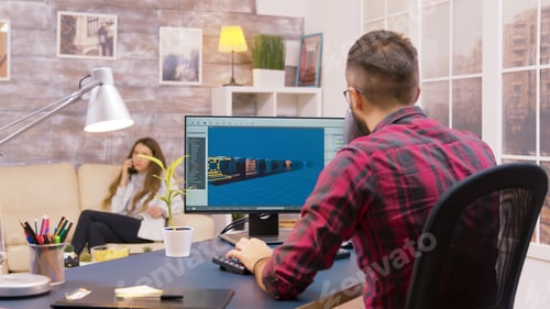 Preview: Over the shoulder shot of young game developer working from home