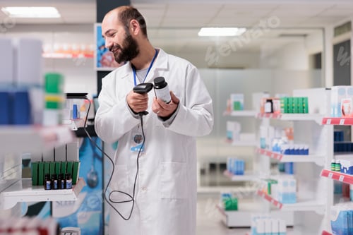 Preview: Caucasian pharmacist holding medicament bottle scanning product bar code