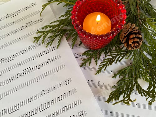 Preview: Sheet music with candle and evergreens